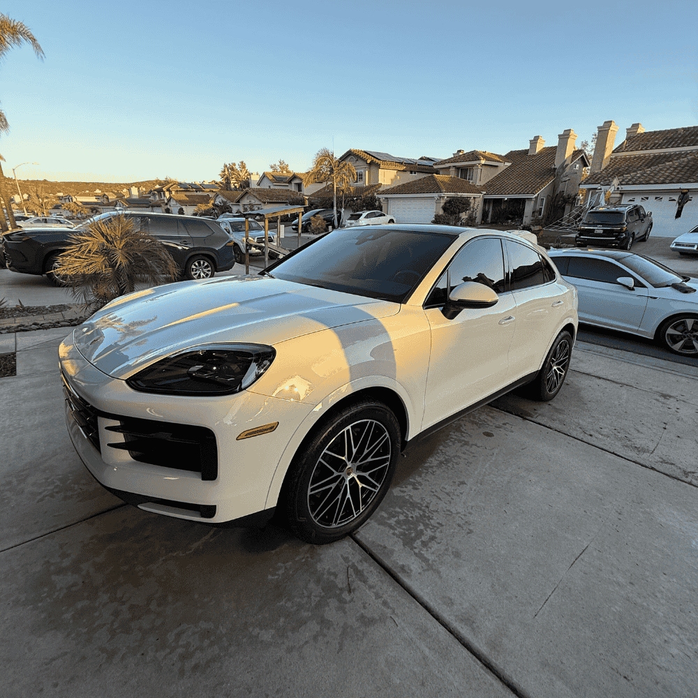 White Porsche SUV with professional ceramic coating showing complete exterior detailing in residential setting