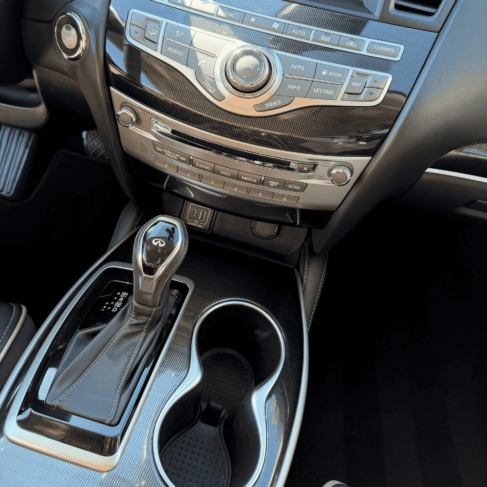 Professional dashboard detailing showing infotainment system and climate controls cleaned to perfection