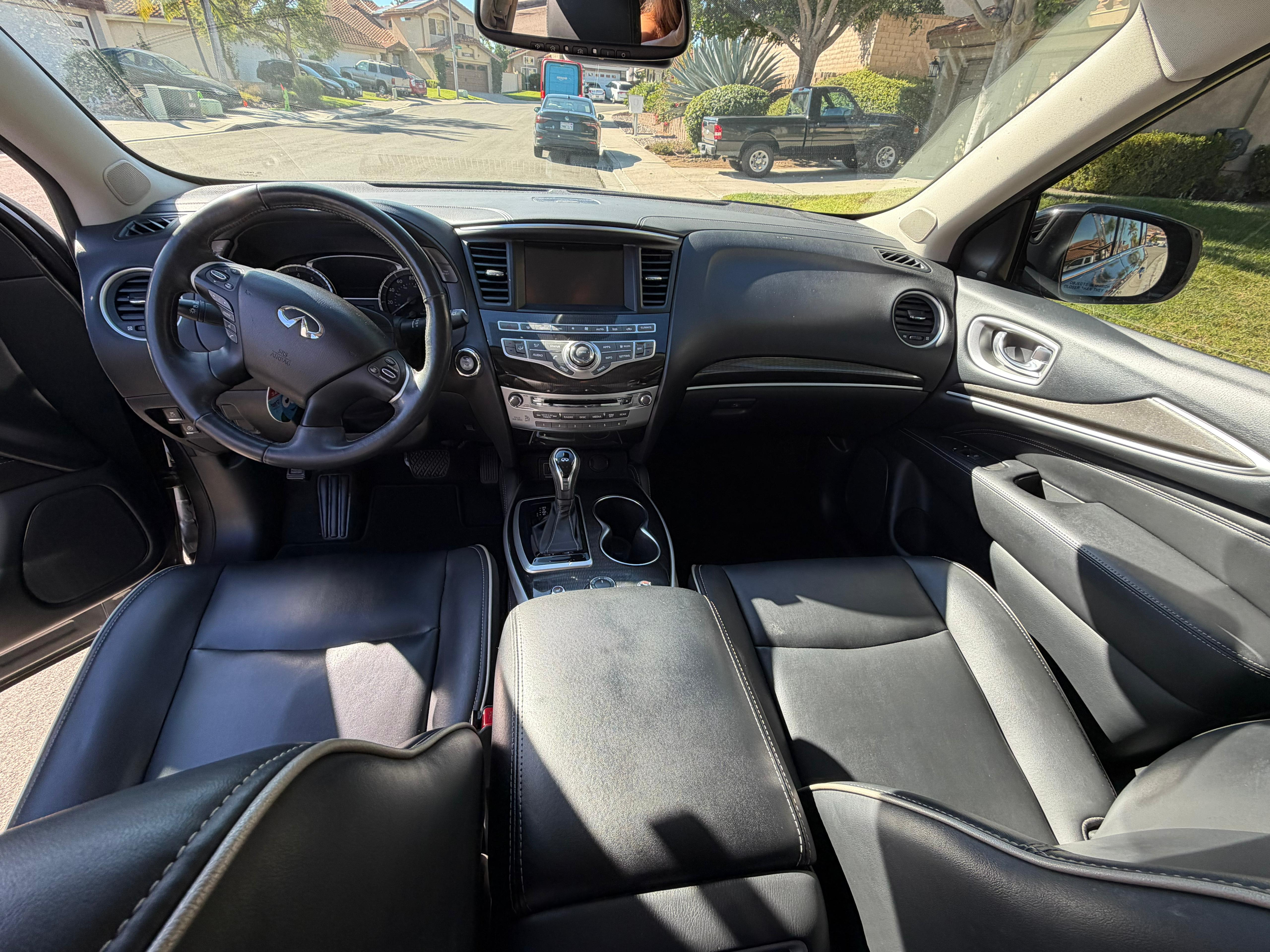 Professional interior detailing showing black and tan leather interior with perfect conditioning