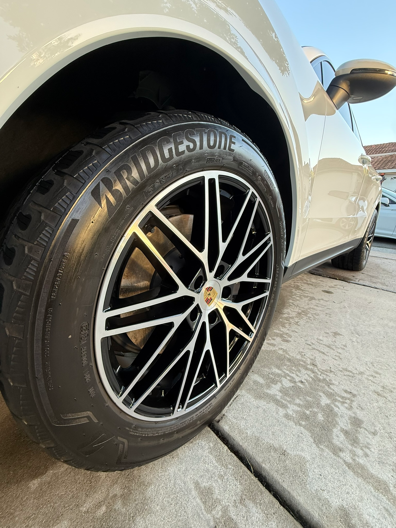Close-up of professionally detailed white luxury wheel showing pristine finish and shine